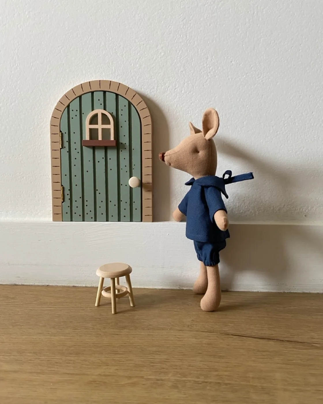 Baluzini mouse beside a miniature door.
